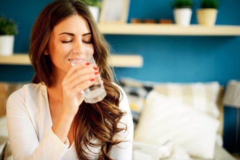 γυναίκα που πίνει νερό, πώς θα ελέγξετε τη γαστρίτιδα με σπιτικά κόλπα
