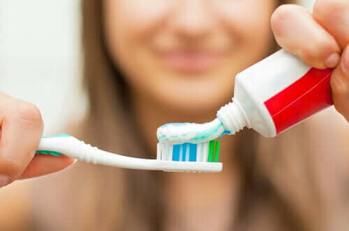 Γυναίκα τοποθετεί οδοντόκρεμα σε οδοντόβουρτσα